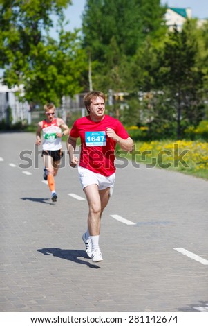 OMSK, RUSSIA - MAY 24 : Marathon runners compete at the Siberian Spring Half Marathon 2015 in Omsk, Russia, May 24,  2015. Male marathon athletes running on street