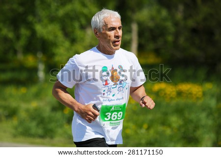 OMSK, RUSSIA - MAY 24 : Marathon runners compete at the Spring Half Marathon 2015 in Omsk, Russia, May 24,  2015. Male marathon athletes running on street