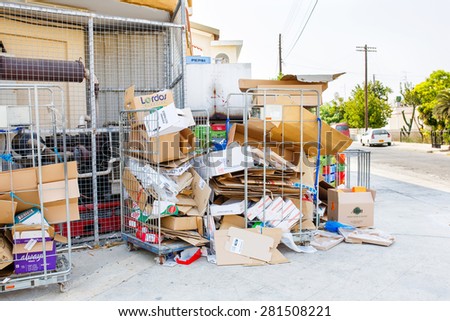 LARNACA, CYPRUS - AUGUST 29, 2014: Various colored cardboard boxes for recycling stored on the street.