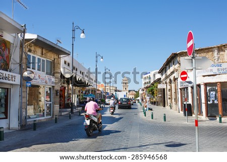 LARNACA, CYPRUS - OCTOBER 3, 2014: The old street with many shops and cafes leads to the Lazarus Church.