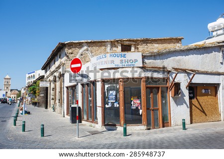 LARNACA, CYPRUS - OCTOBER 3, 2014: The old street with many shops and cafes. Closed souvenir shop. One of many deserted shops in Larnaca because of Economic crash in Cyprus.