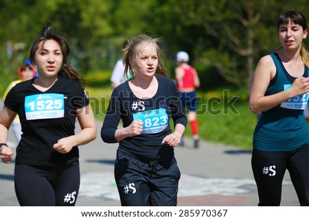 OMSK, RUSSIA - MAY 24 : A group of women marathon runners compete at the Spring Half Marathon 2015 in Omsk, Russia, May 24,  2015. Marathon athletes running on street
