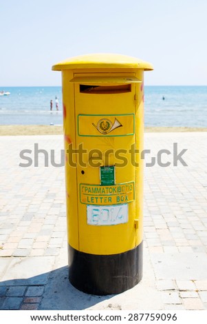 LARNACA, CYPRUS - 22 AUGUST, 2014 - Pillar box. Cyprus Postal Services. A legacy of British colonial rule is the use of pillar boxes, repainted yellow after independence.