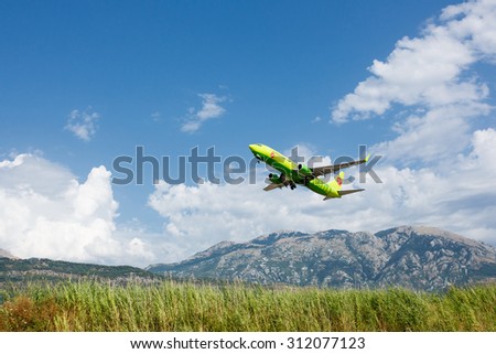 TIVAT, MONTENEGRO - AUGUST 03, 2015 : Boeing 737 Next Gen S7 Siberia Airlines taking off at Tivat Airport, Montenegro. Mountains view.