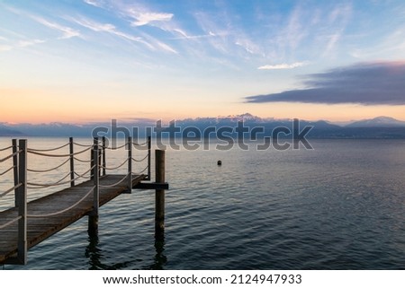 Wooden pontoon opening onto the snow-capped Alps on the shores of Lake Geneva in Morges at sunset (Canton of Vaud, Switzerland) Stock fotó © 