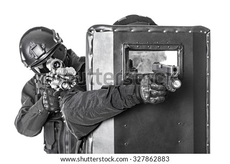 Spec ops police officers SWAT with ballistic shield studio shot