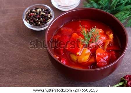 red chili peppers. close-up lecho of tomatoes and red peppers with ingredients on the table. lecso national dish of Hungarian cuisine greens in the brown bowl. Hungarian food with copy space. Stock fotó © 