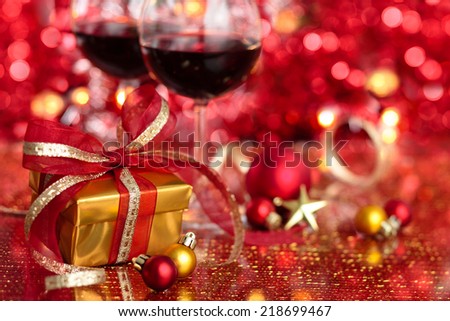 Gift and wine for holidays against blurred lights.
