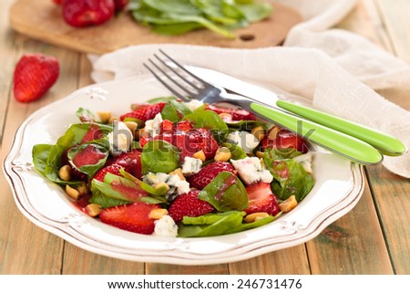 Fresh spinach salad with peanuts and blue cheese.