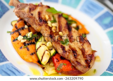 Preserved grilled meat and vegetables: pumpkin, zucchini, pepper, peach.