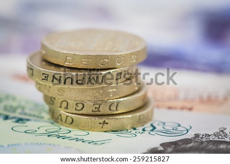 Stack of UK Pound Coins on Notes