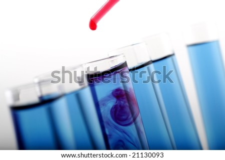 Test tubes with blue liquid and dropper with red liquid on white background.