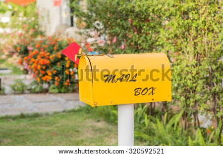 yellow Mail Box in Front of a House.