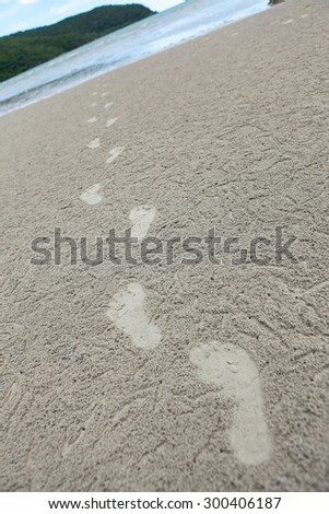 Footprints Walking on the sand . Represents a move forward . and Travel