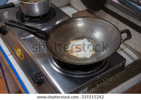 THAILAND BANGKOK 21 SEPTEMBER 2015: Fried egg in a frying pan Thai style to making breakfast.On 21 September 2015,Bangkok Thailand