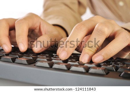 Woman hand typing on black computer keyboard isolated over white background