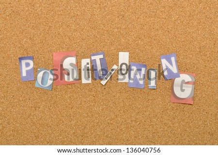 Positioning word made from newspaper letter shot over pinboard background