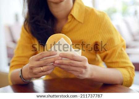 Woman eat donut in the restaurant