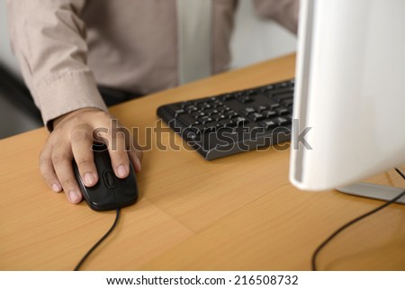Business man typing with keyboard on wooden desk