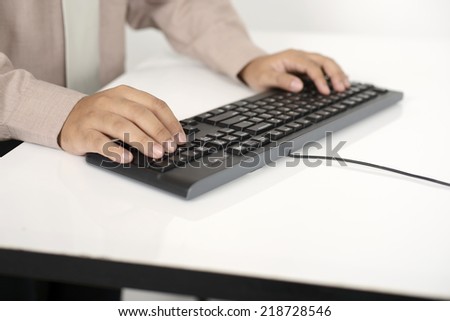 Business man typing with the keyboard on white desk