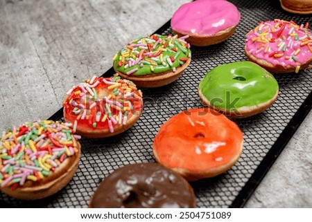 Similar – Image, Stock Photo Donuts in a row on blue background. Homemade ring doughnuts, top view