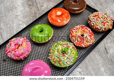 Similar – Image, Stock Photo Donuts in a row on blue background. Homemade ring doughnuts, top view