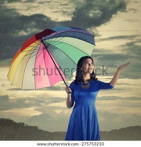 Woman using hand to know when the rain stop