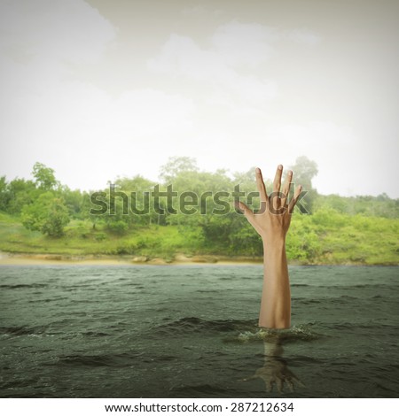 single hand of drowning man in sea asking for help