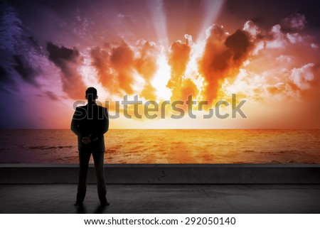 Asian business man looking the cloud on the sea. Business success concept