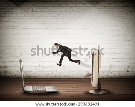 Business woman jumping from desktop computer to laptop. Switch to mobile technology