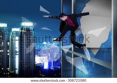 Man jump through office building window.Business challenge concept
