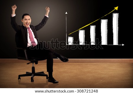 Business man smile while sitting. With increase chart on the background