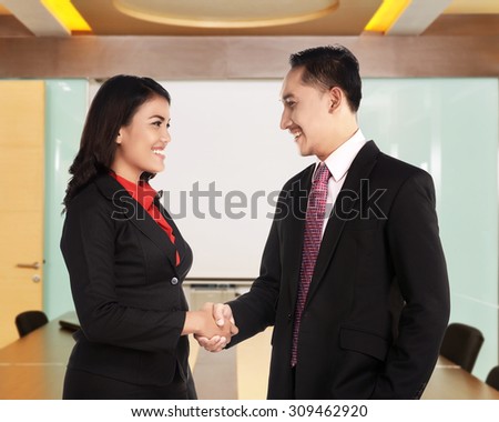 Business man and woman hand shake in the office