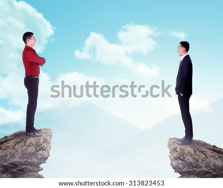 Two business man standing on the top of the mountain. Business competition concept