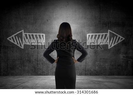 Business woman has to choose between two way. Business option conceptual
