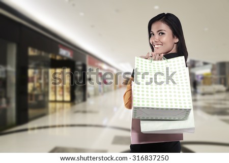 Asian woman holding shopping bag. Shopping sale concept