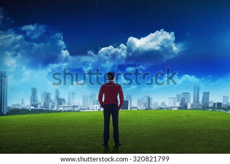 Asian business man looking the city on the park. Business vision concept
