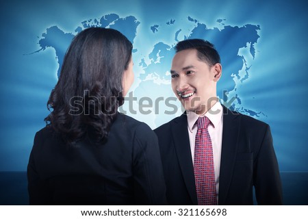 Casual business meeting over world map background