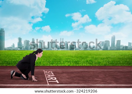 Business person  in ready position to race on the track. Business competition concept