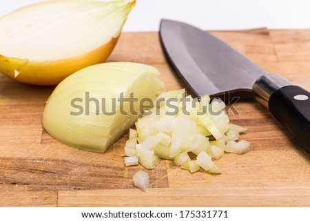 Chopped onion with knife on a wooden board