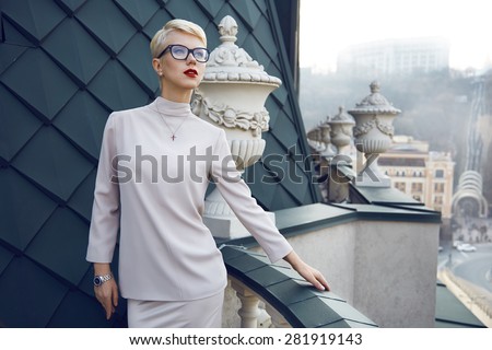Beautiful sexy young business woman blond hair evening makeup wearing dress suit top  skirt high heels shoes business clothes for meetings walks summer fall collection perfect body shape glasses hotel