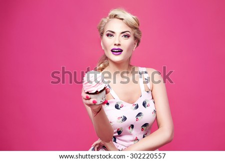 Portrait of young beautiful perfect sexy woman with blond hair, fashionable styling evening make-up organic cosmetics, facial features in a beauty salon eat sweet cupcake cake diet and manicure