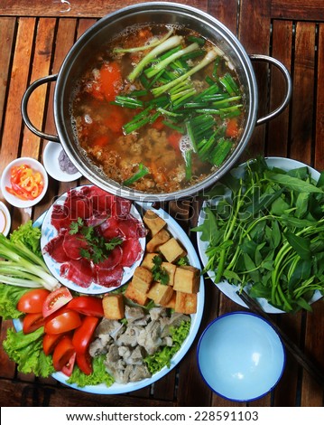 Crab paste hot pot (Lau rieu cua), Vietnamese Cuisine. This combo consits of crab paste, fresh beef (dump in the soup), vegetable, tofu, cooked pork, tomatoes, and chilli.\
A good meal for your health.