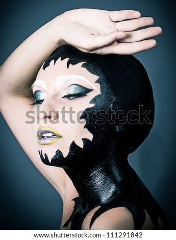 Portrait of a beautiful alien lady with original dark make up