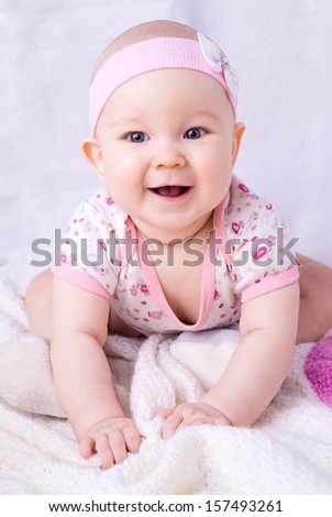 Baby with blue eyes smiling, 7 month newborn baby