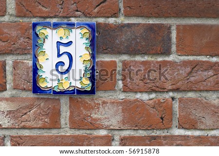 Brick wall with house number plate. Suffolk, England