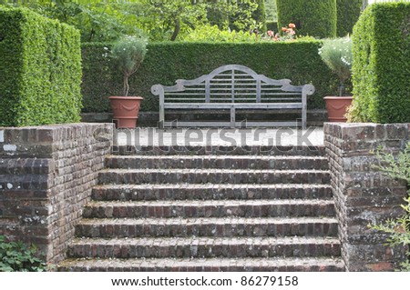 Wooden garden bench in English garden, Kent UK