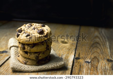 Chocolate cookies on white linen napkin on wooden table