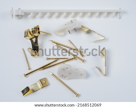 Picture frame wall hanging Accessory Kit of white nylon and gold brass hooks and brad nails Imagine de stoc © 