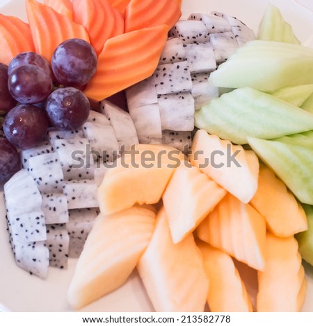 Variety of fresh fruit,Colorful fruit platter with watermelon, cantaloupe, grapes, oranges, Dragon fruit and mint